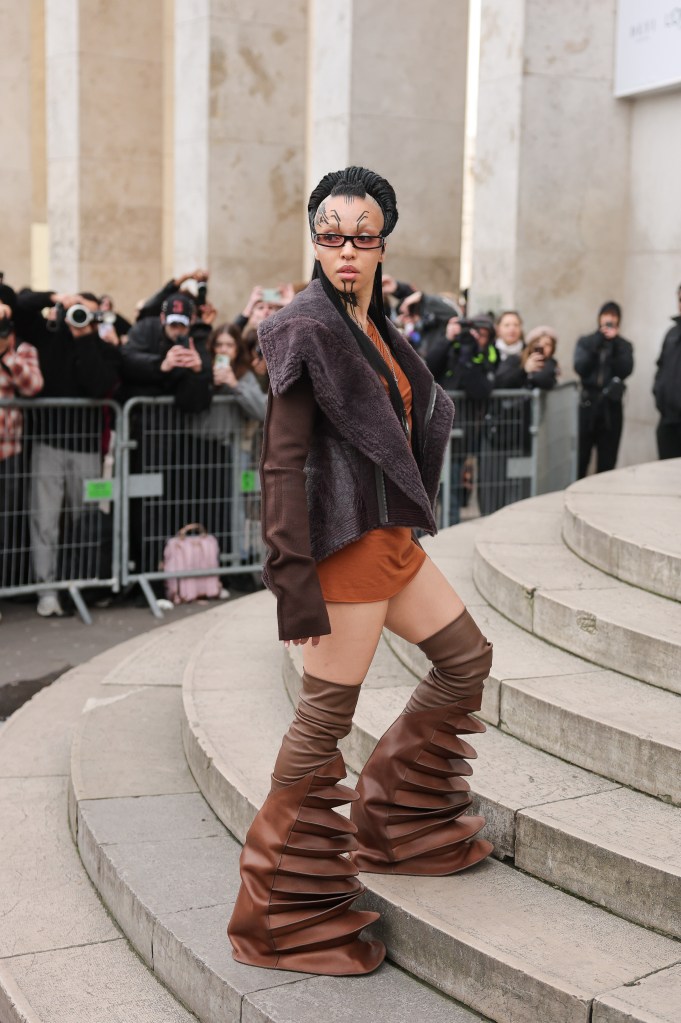 FKA twigs rocks some face tattoos and funky boots while attending the Rick Owens Menswear Fall-Winter 2025/2026 show in Paris.