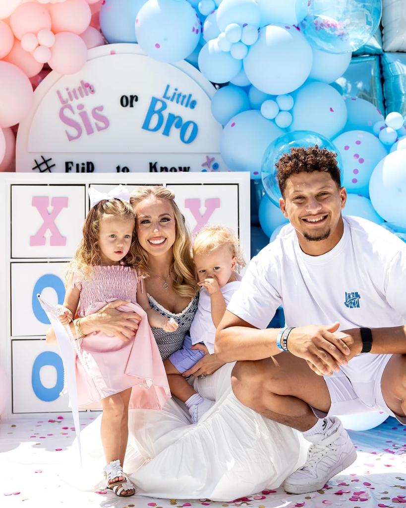 Patrick and Brittany Mahomes posing with their two kids