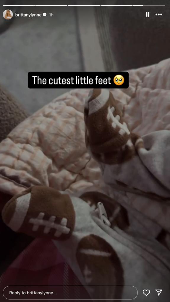 Brittany and Patrick Mahomes' daughter's feet in a football onesie 