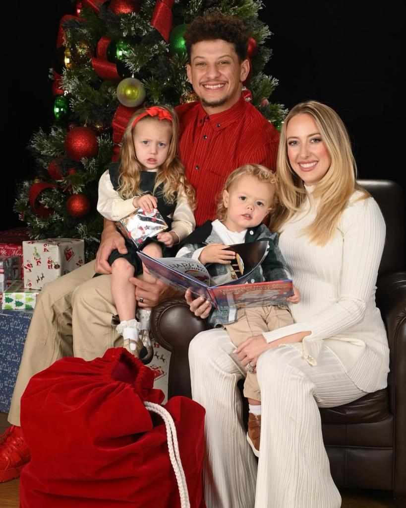 Patrick and Brittany Mahomes posing with their two kids