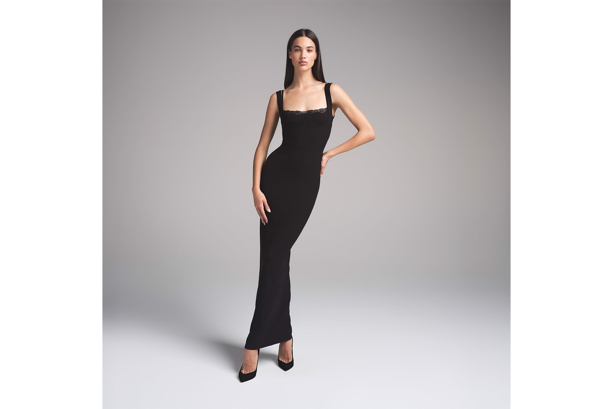 A model in a black lace dress